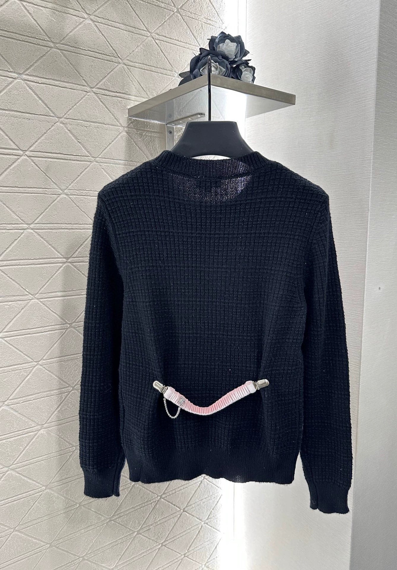 C 25 A simple logo sweater with a chain detail at the back waist.