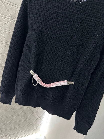 C 25 A simple logo sweater with a chain detail at the back waist.